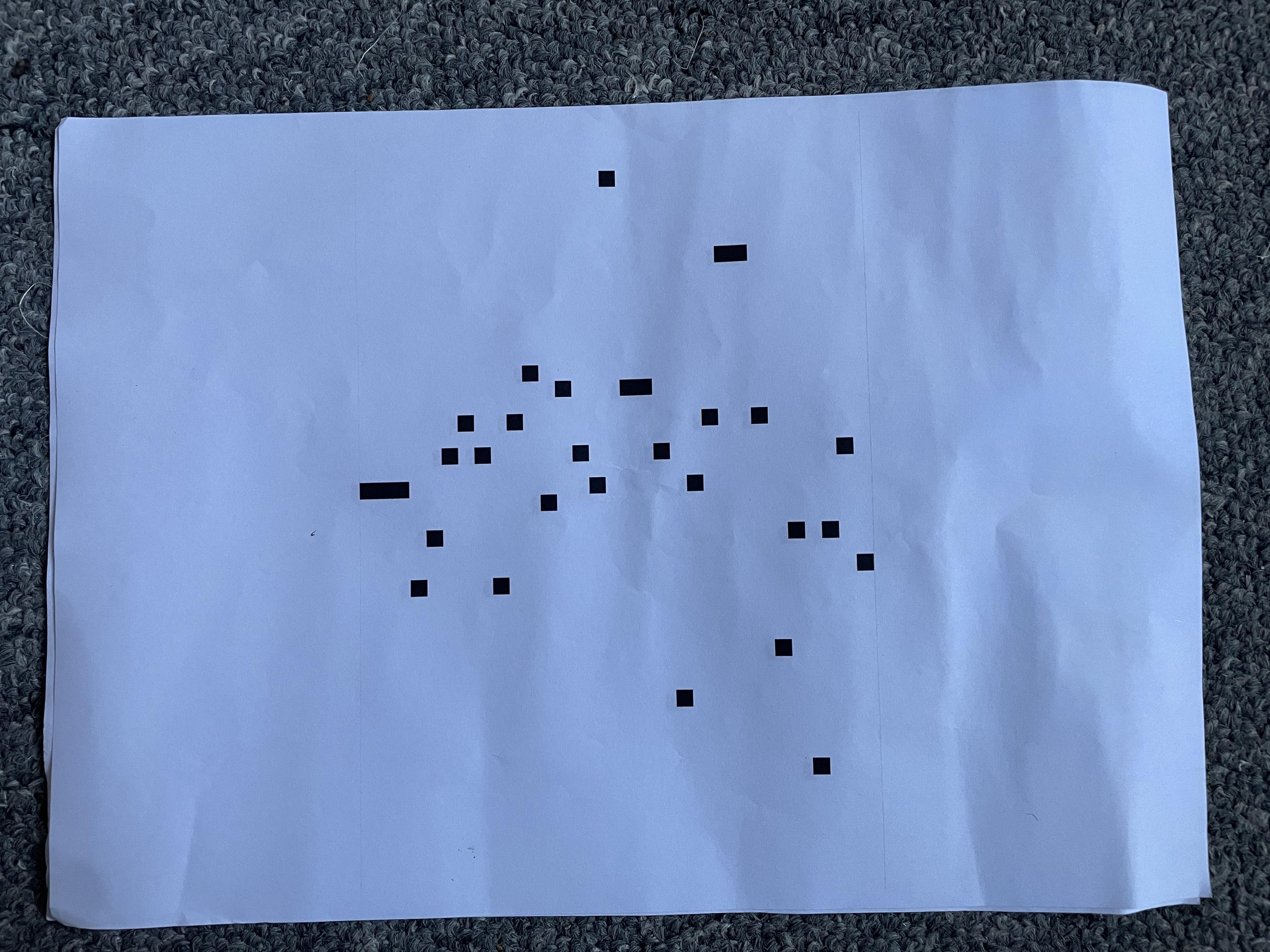 A series of seemingly randomly spaced squares on an A4 bit of paper