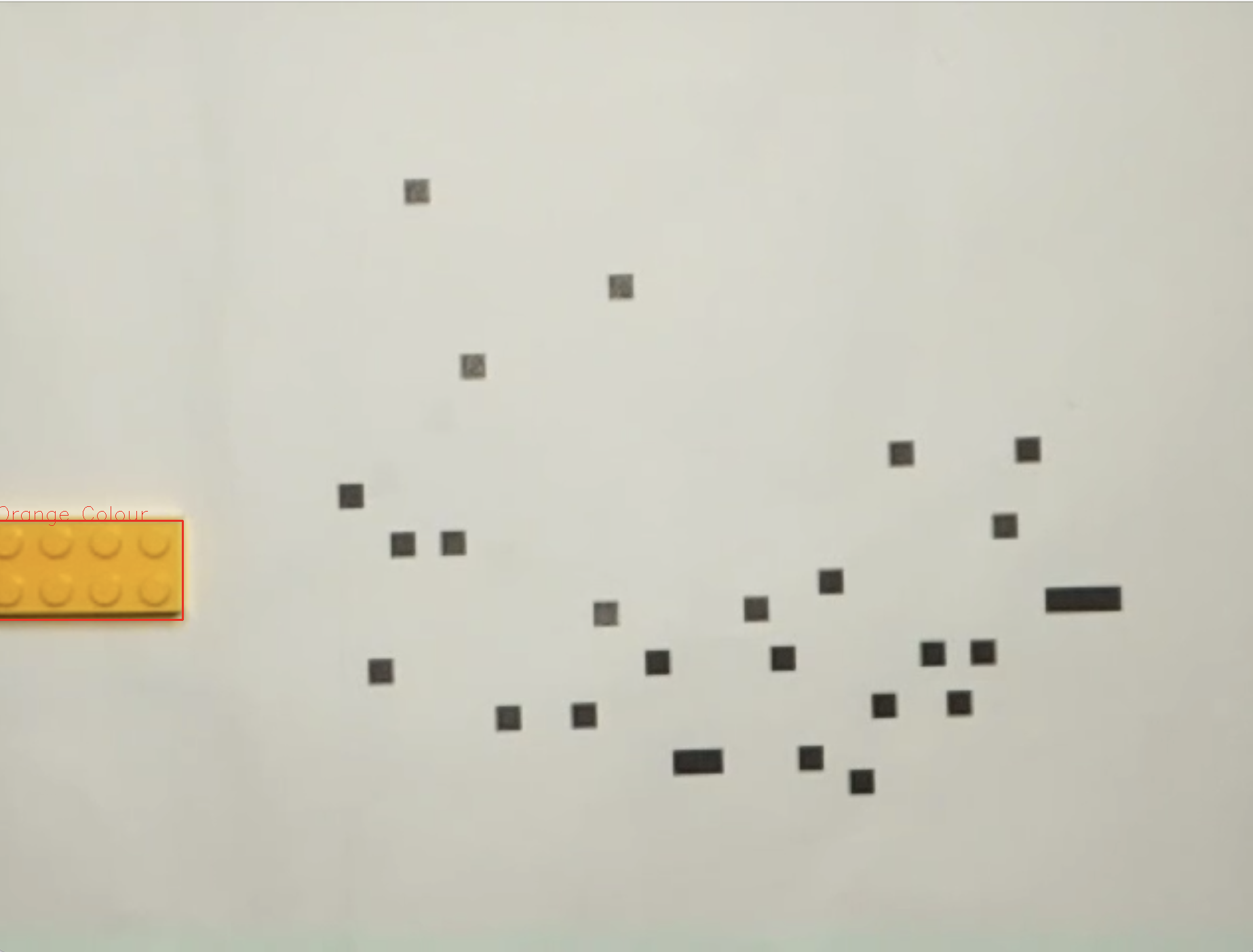 a picture of my data (black squares on white) via a camera and opencv with an orange lego brick outlined in red
