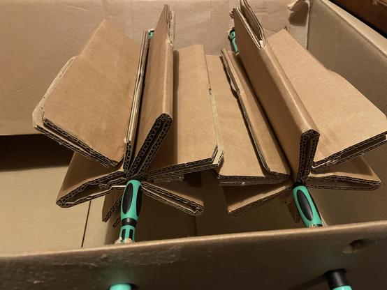 cardboard cogs balenced using some screwdrivers